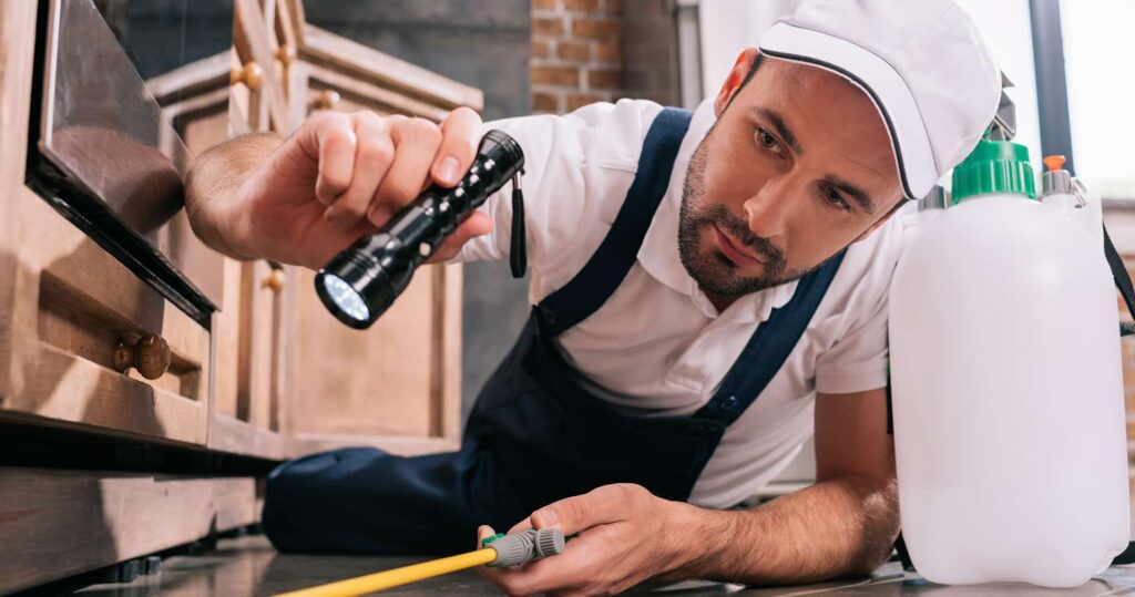 Pest-Control-Pro-Inspecting-Baseboards