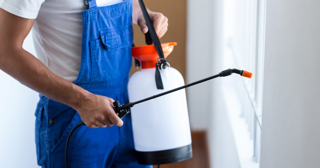 Pest Control Worker Holding Solution