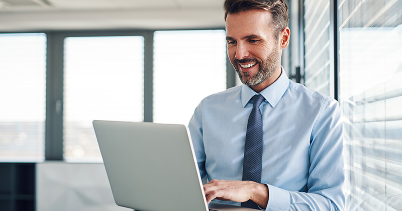 Happy Business Owner on Computer