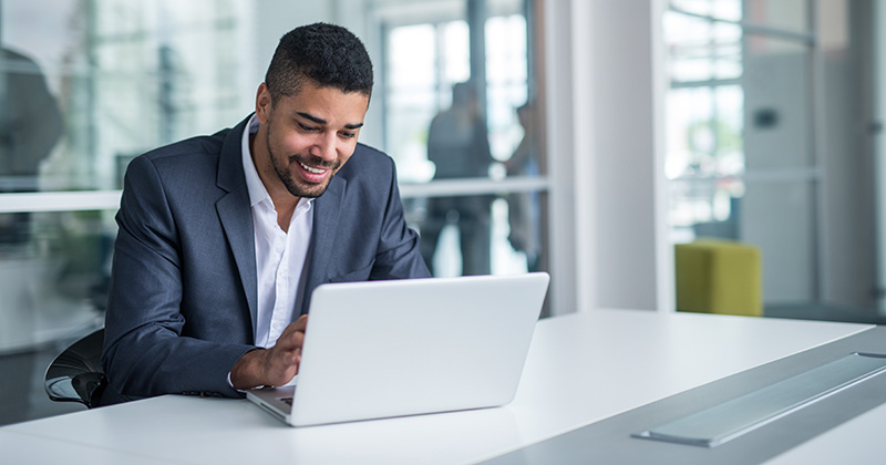 Smiling Worker On Laptop