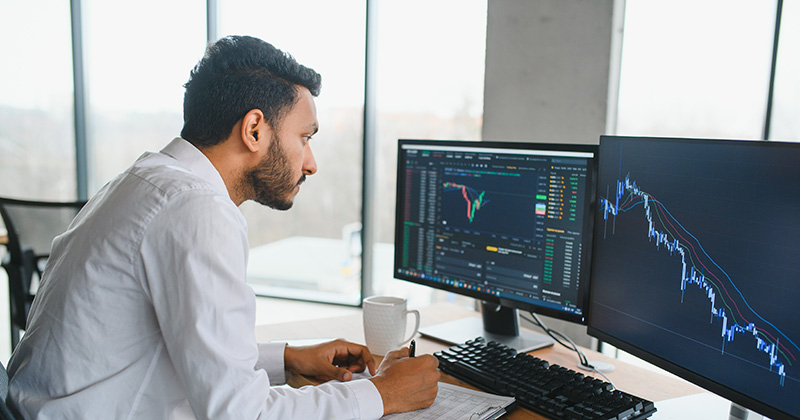 Man Looking at Profit Margin on Monitor