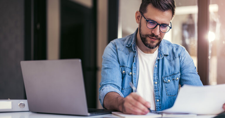Focused Male Writing Invoice