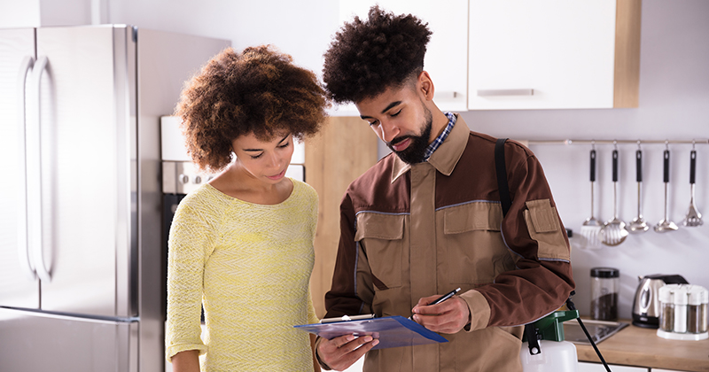 Worker and Customer Reviewing Invoice Together