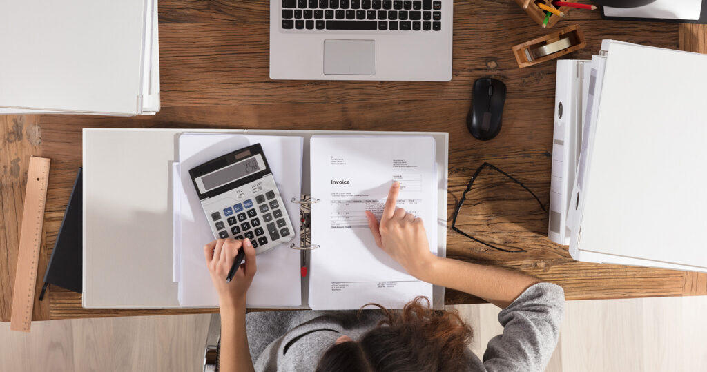 Birdseye View of Woman Calculating Profit Margin