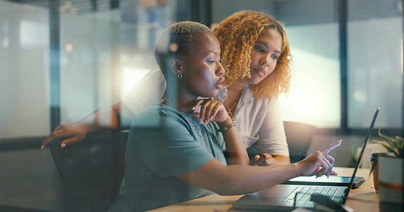 Two women in an office working on advertising strategies