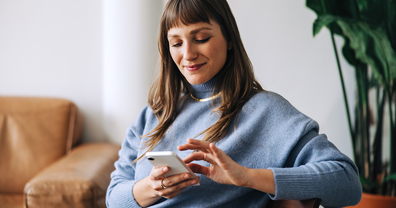 Young woman on her phone looking at pest control advertisements