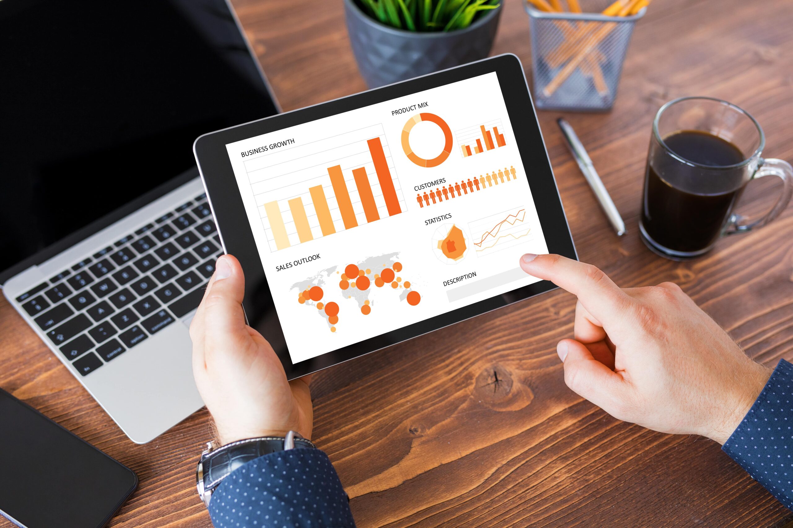 a person using a tablet to show business metrics