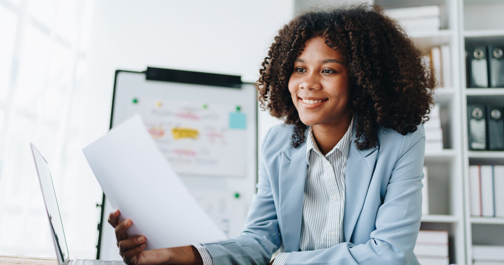 Smiling woman working on sales plan