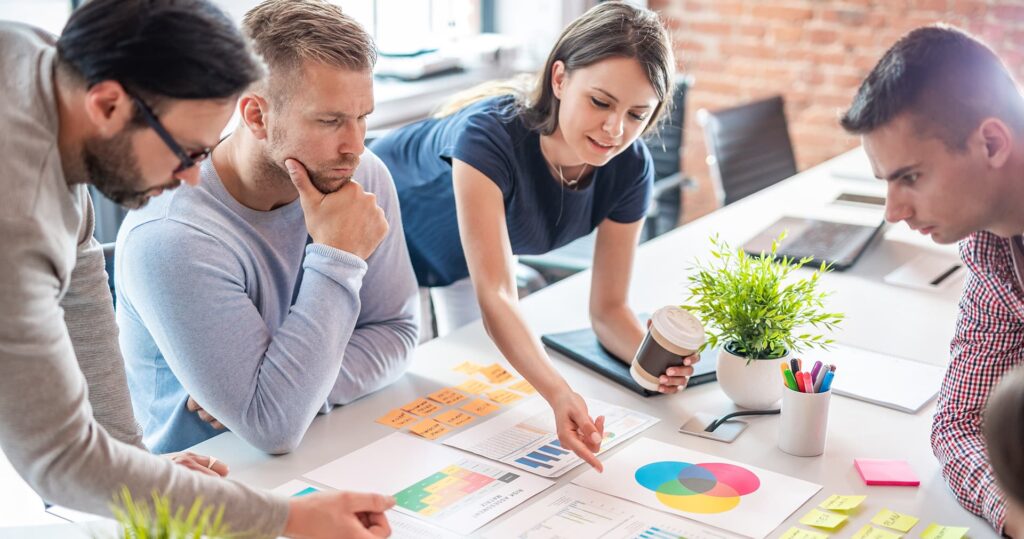 Group of coworkers look over business plan