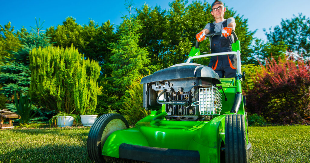 Landscape worker on standing mower