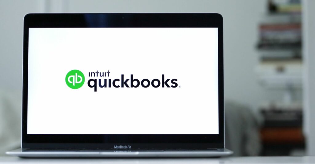 Laptop displays the logo of Quickbooks, an accounting software program