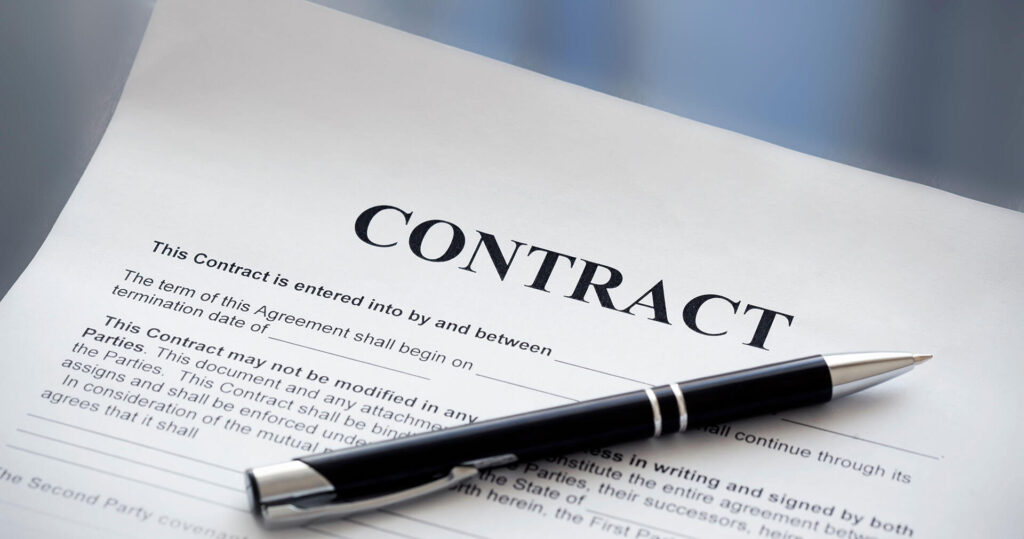 lawn care contract on a table with a pen on the document